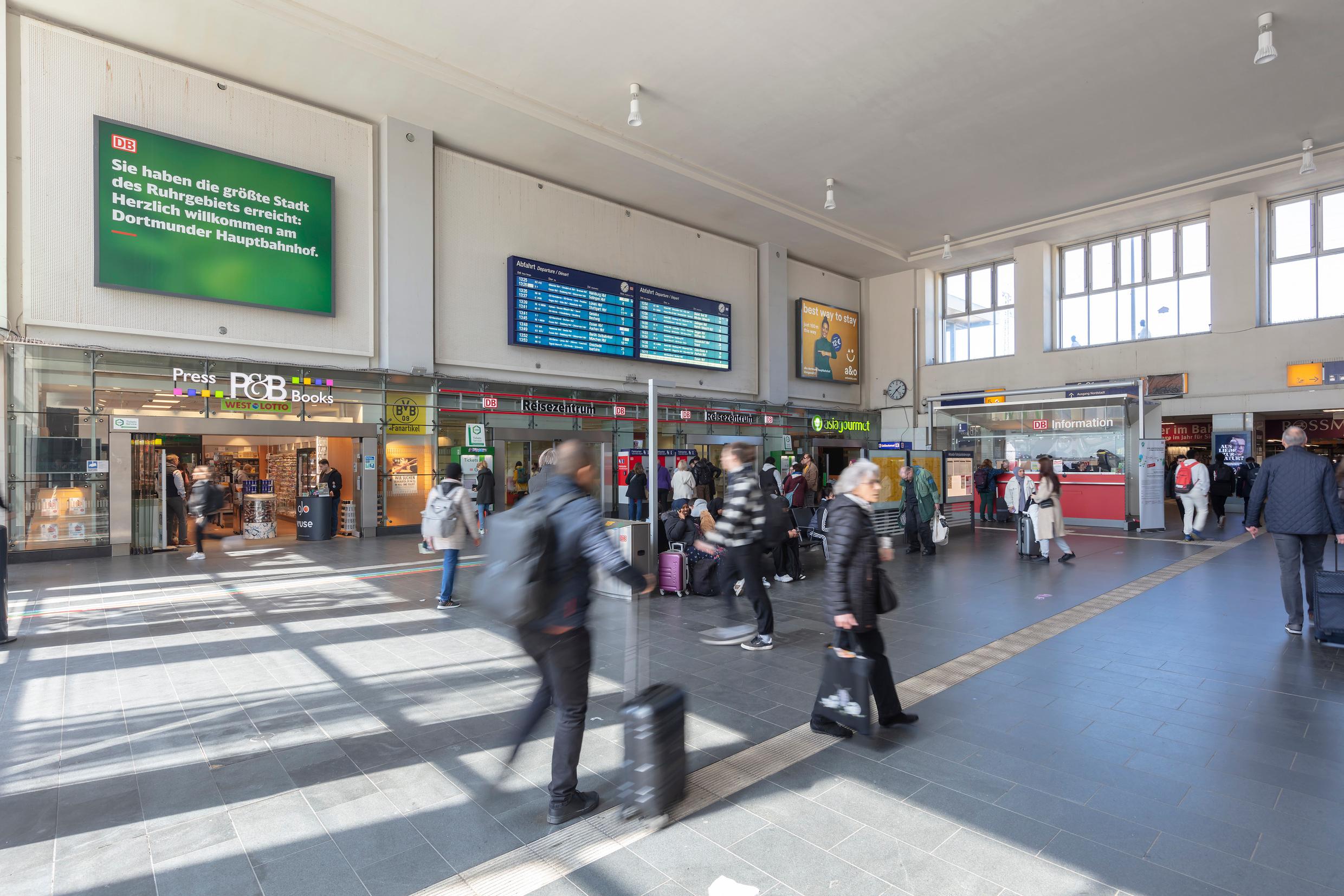 People pass through the reception hall of Dortmund Hauptbahnhof.